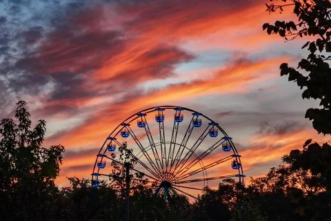 Ferris wheel at sunset in Tineretului park, Bucharest, Romania Stock Photos