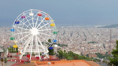 Ferris Wheel on Tibidabo mountain over Barcelona City Stock Footage 99655784