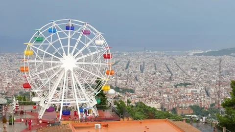 Ferris Wheel on Tibidabo mountain over Barcelona City Stock Footage 99657667
