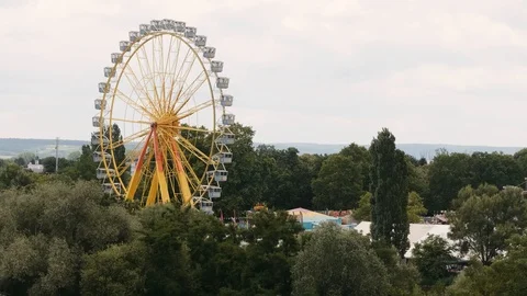 Ferris Wheel turning with trees in foreground Stock Footage 91135248