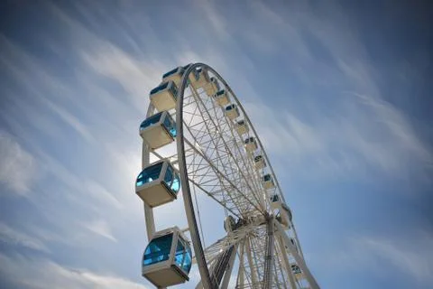 Ferris wheel under blue dramatic skies Stock Photos
