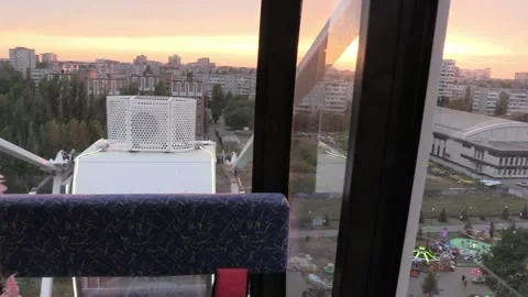 Ferris wheel. View from the booth to the children's amusement park at sunset.s Video stock 160355879