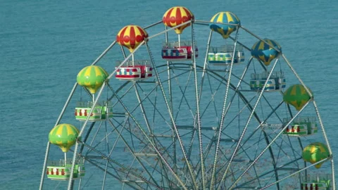 The Ferris Wheel is Working Behind the Black Sea Waves Stock Footage 313508218