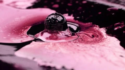 Ferrofluids dance and move toward magnets in pink beautiful science background Stock Footage 147356688