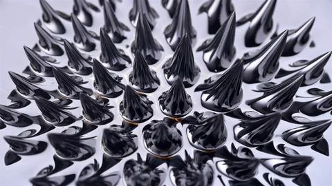 Ferromagnetic fluid (Ferrofluid) when exposed to a magnetic field creates ama Stock Photos