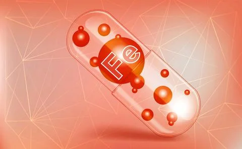 Ferrum, Fe, vitamin inside a translucent capsule, trace element, on a brown.. Stock Photos