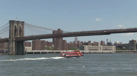 Ferry and fast boat under Brooklyn Bridge Stock Footage 40140857