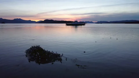Ferry and lighthouse in sunset Stock Footage 218255686