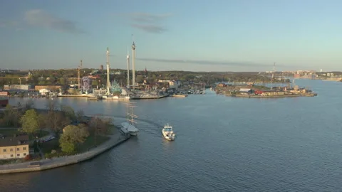 Ferry and Sightseeing boat in front of Gröna Lund amusement park, aerial view Stock Footage 131533492