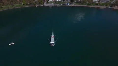Ferry approaching camera on mountain lake Видео 332370644