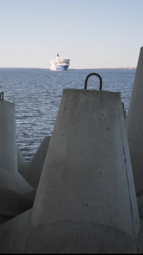 Ferry approaching harbor behind breakwater Видео 332306732