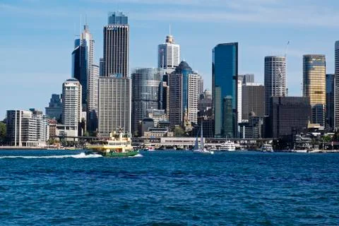 Ferry boat approaching teminal at  Circular Quay and skyline of Sydney, Stock Photos