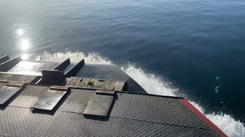 Ferry boat moving fast over perfect calm water. Water splashing over the bow. Video stock 225433387