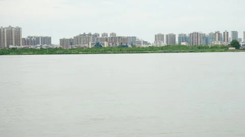 Ferry Boat Navigating Wide River with Bridge in Background Видео 334226847