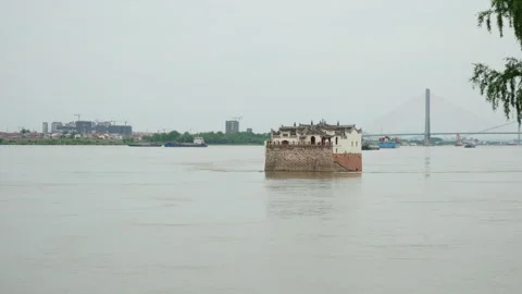 Ferry Boat Navigating Wide River with Bridge in Background Видео 334227487