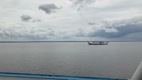 Ferry Boat With Passenger On It Crossing River Under Cloudy Sky Stock Footage 232310032