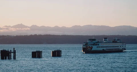 Ferry Boat Pulls into dock with Olympic mountains in view Stock Footage 102466363