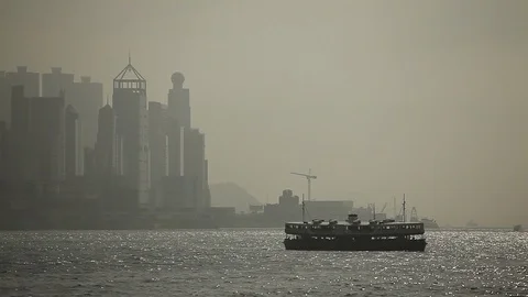 Ferry boat sailing in the river in front of Hong Kong skyline Stock Footage 97102141