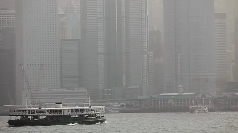 Ferry boat sailing in the river in front of Hong Kong skyline Stock Footage 97102261
