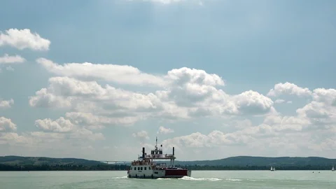 Ferry boat sets sail full on lake Balaton/Hungary at sunny cloudy day. 4k Stock Footage 116119013