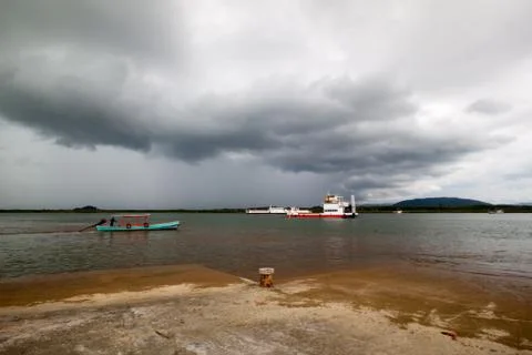 Ferry boat under rainstrom cloud Stock Photos