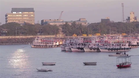 Ferry boats parked in the sea while a small boat passing from the front Stock Footage 72476997