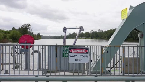 Ferry cable and mechanical system with river and opposite bank in background. Stock Footage 332956692