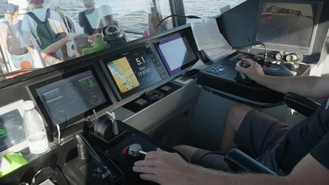 Ferry captain maintains heading on scheduled harbor route using digital helm Stock Footage 344866220