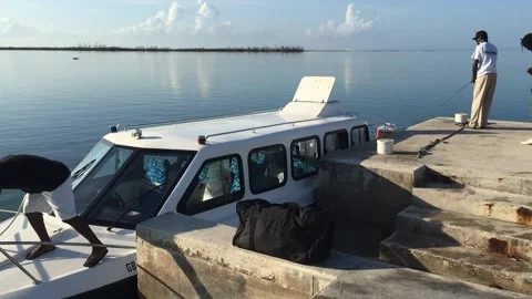 Ferry Captain Securing Boat at McClean Town Ferry Dock, Grand Bahama Stock Footage 135983597