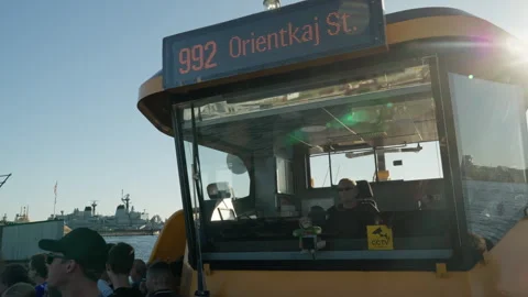Ferry captain steers electric harbor bus on route 992 to Orientkaj in Copenhagen Stock Footage 344866615
