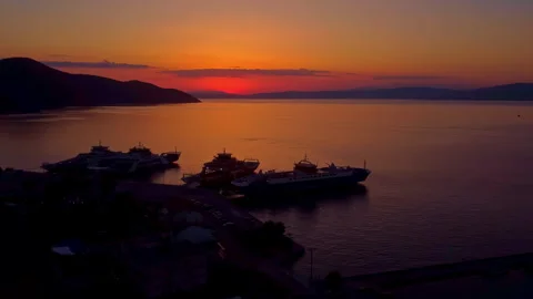 Ferry completing docking at Thasos port after sunset aerial shot on calm sea 스톡 동영상 332557445