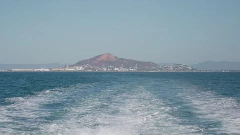 A ferry creating waves and splashes as it moves through the water with Castle Stock Footage 346491989