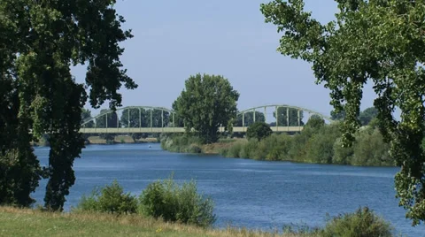 Ferry crossing river Meuse + train passing Ravenstein railway bridge Stock Footage 32966703