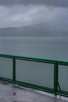 Ferry deck and railing on a boat sailing past the San Juan Islands Stock Photos