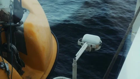 Ferry Deck Detail Featuring a Bright Yellow Life Raft and Safety Lamp Stock Footage 331166301