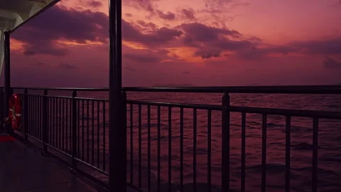Ferry Deck Railing Framing Open Sea And Fiery Sunset Sky Creating Strong Sense o Video stock 328408375