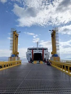 Ferry docking at the harbor with a gate opening 写真素材