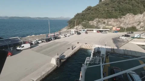 Ferry Docking to Port while a Man is Tying the Rope Stock Footage 242863996