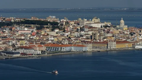 Ferry floating the surface of Tagus river waters. View of the old city of Lisbon Video stock 105637871