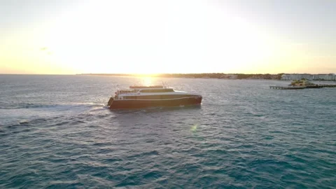 Ferry in front of sunset pulling into harbor 4K Stock Footage 314753943