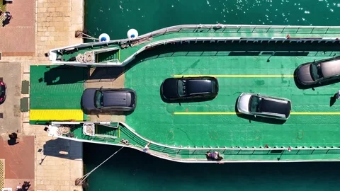 Ferry loading vehicles at dock location with traffic approaching and departing Stock Footage 338165108