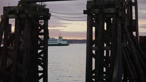 Ferry moves through the bay framed by old pier remnants in Port Townsend Was Stock Footage 263107996