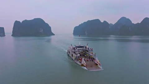 Ferry Navigating Through the Serene Waters of Ha Long Bay Stock Footage 280951313