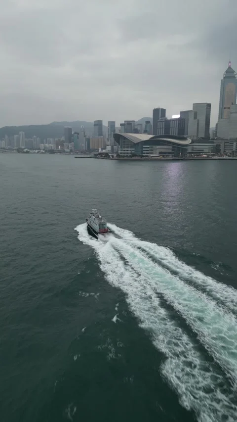 Ferry Navigating Victoria Harbour Towards Hong Kong Skyline in Hong Kong Stock Footage 335811229