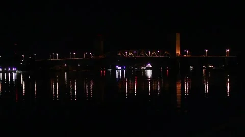 Ferry at night passes by bridge Stock Footage 1094242