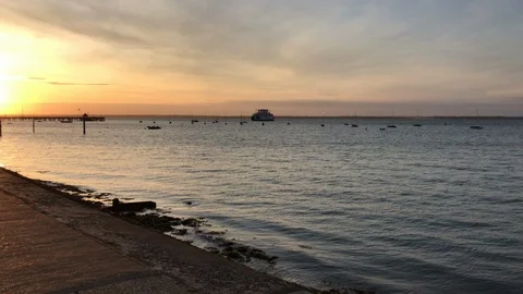 Ferry in the ocean on a sunset in England Stock Footage 114752482