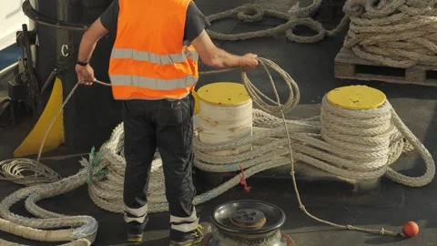 Ferry operator preparing mooring rope on deck, Portoferraio, Italy. June 2, 2026 Видео 336315163