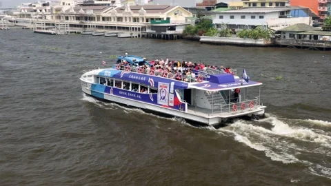 The Ferry with passengers on a upper deck sails along the Chao Phraya River Stock Footage 237139909