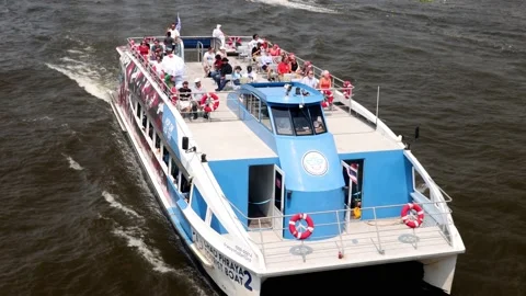 The Ferry with passengers on a upper deck sails in Bangkok Stock Footage 240001555