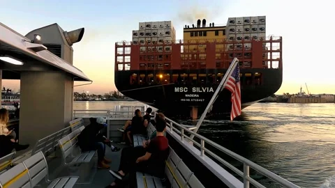 Ferry Passengers Waving at Crew Aboard a Container Ship (at sunset) Video stock 151480692